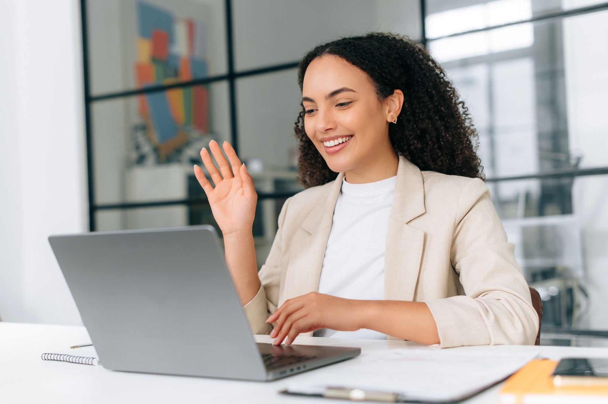 Online video conference. Brazilian or hispanic business woman, corporate manager, team leader, sits